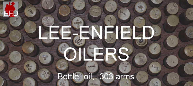 A box displaying several dozen brass oil bottles with a variety of marks, symbols and codes visible on the end of each oil bottle.  Photo caption “Lee-Enfield Oilers” and “Bottle, oil, .303 arms.”